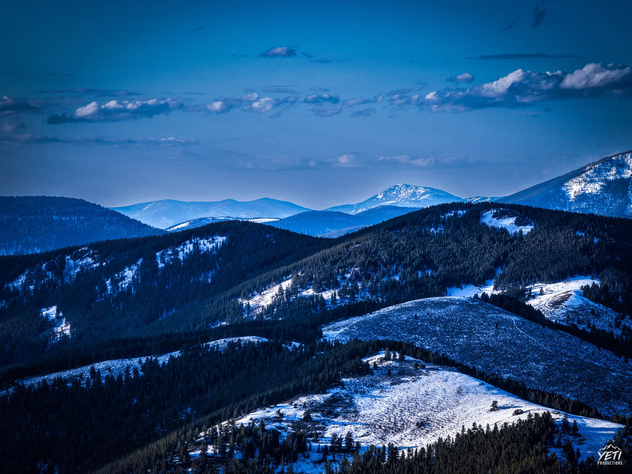 Snow-dusted Montana ridges at blue hour
